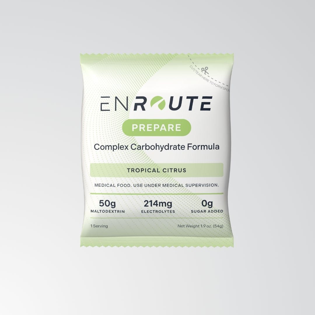 ENROUTE Prepare packaging. Complex carbohydrate formula. Tropical citrus flavor. Medical food. User under medical supervision. 50g maltodextrin, 214mg electrolytes, 0g sugar added. 1 serving. Net weight 1.9oz. (54g)