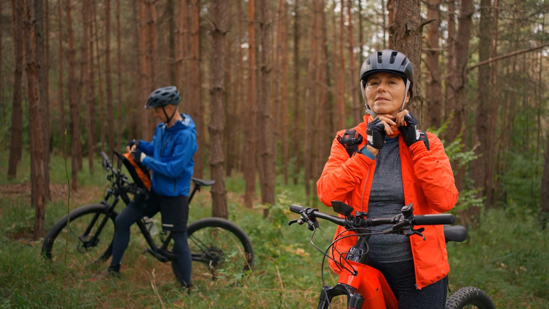 Active couple biking in the woods