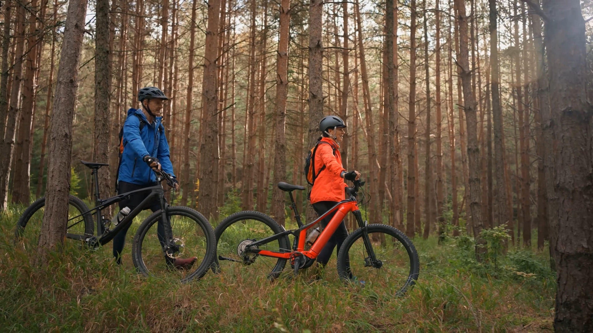 Active couple biking in the woods
